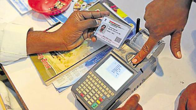 A man gives a thumb impression to withdraw money from his bank account with his Aadhaar card in Hyderabad. (AFP File Photo) A man gives a thumb impression to withdraw money from his bank account with his Aadhaar card in Hyderabad. (AFP File Photo)