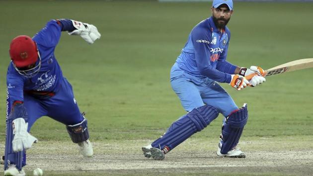 Afghanistan's wicketkeeper Mohammad Shahzad, left, runs to field the ball after a shot played by India's Ravindra Jadeja, right, during the one day international cricket match of Asia Cup between India and Afghanistan in Dubai, United Arab Emirates, Tuesday, Sept. 25, 2018. (AP Photo/Aijaz Rahi) (AP)
