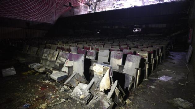 The complex was sealed, but the hole in the building’s wall was large enough for vagabonds and the homeless to enter at will. It was dark inside. The power supply was snapped that night. Soft drink bottles lay strewn on the floor of the main hall. Some of them were never opened. Strewn across the hall, in the balcony, below the charred seats are shoes covered with 21 years of soot. (Sanchit Khanna / HT Archive) The complex was sealed, but the hole in the building’s wall was large enough for vagabonds and the homeless to enter at will. It was dark inside. The power supply was snapped that night. Soft drink bottles lay strewn on the floor of the main hall. Some of them were never opened. Strewn across the hall, in the balcony, below the charred seats are shoes covered with 21 years of soot. (Sanchit Khanna / HT Archive)