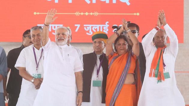 PM Narendra Modi ,CM Vasundhara Raje and newly appointed state BJP President Madanlal Saini greet public , on a very humid day at the Pradhanmantri - Labharthi Samvad ( Prime Minister - Benificiaries Conversation) meeting, at Amrudon Ka Bagh, in Jaipur. (HT File Photo) PM Narendra Modi ,CM Vasundhara Raje and newly appointed state BJP President Madanlal Saini greet public , on a very humid day at the Pradhanmantri - Labharthi Samvad ( Prime Minister - Benificiaries Conversation) meeting, at Amrudon Ka Bagh, in Jaipur. (HT File Photo)