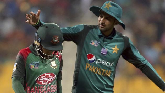 Pakistan's Shoaib Malik, right, pats Bangladesh's Mushfiqur Rahim on scoring 99 runs after Rahim's dismissal during the one day international. (AP)