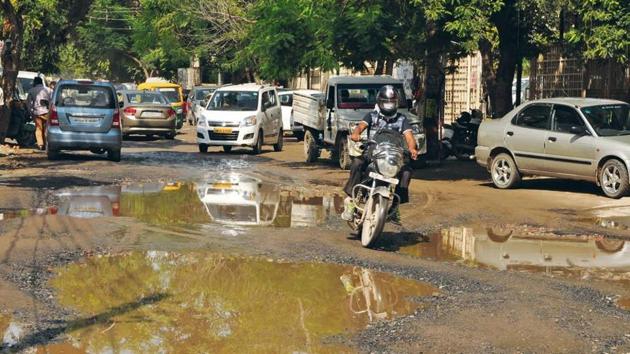 Broken roads mar the stretches of Sushant Lok, especially in Block-C, as they make commute hard and also are a site for mosquito breeding after rains. (HT Photo) Broken roads mar the stretches of Sushant Lok, especially in Block-C, as they make commute hard and also are a site for mosquito breeding after rains. (HT Photo)