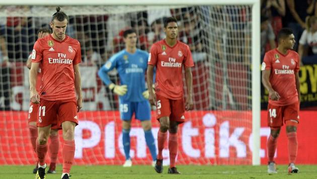 Real Madrid's Welsh forward Gareth Bale (L) and teammates react to sevillas third goal during the Spanish league football match Sevilla FC against Real Madrid CF (AFP) Real Madrid's Welsh forward Gareth Bale (L) and teammates react to sevillas third goal during the Spanish league football match Sevilla FC against Real Madrid CF (AFP)