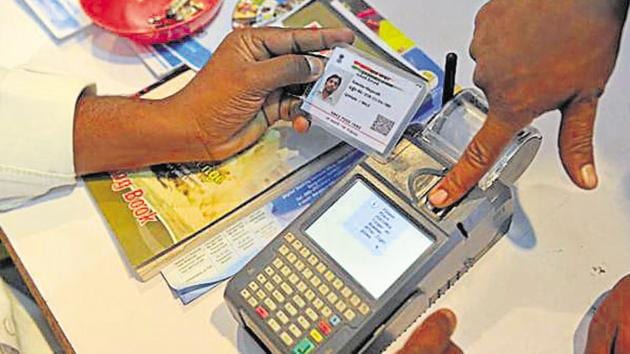 (FILES) This file photo taken on January 18, 2017 shows a visitor giving a thumb impression to withdraw money from his bank account with his Aadhaar or Unique Identification (UID) card during a Digi Dhan Mela, held to promote digital payment, in Hyderabad. (AFP) (FILES) This file photo taken on January 18, 2017 shows a visitor giving a thumb impression to withdraw money from his bank account with his Aadhaar or Unique Identification (UID) card during a Digi Dhan Mela, held to promote digital payment, in Hyderabad. (AFP)