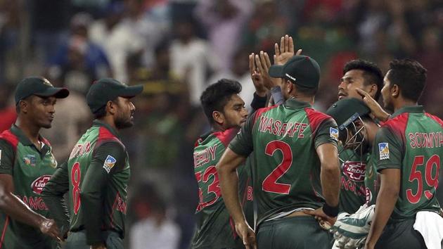 Bangladesh's wicketkeeper Liton Das, second right wearing helmet, celebrates with teammates. (AP)
