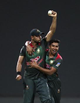 Bangladesh's captain Mashrafe Mortaza, left, holds the ball as he celebrates with teammate Soumya Sarkar the dismissal of Pakistan's Shoaib Malik. (AP)