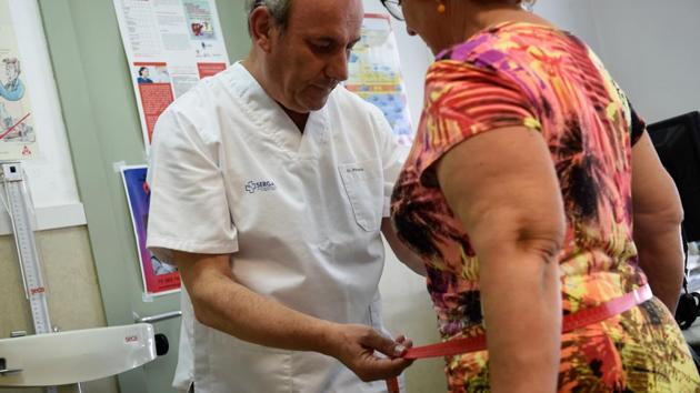 A 63-year-old family doctor Carlos Pineiro weighs a woman at the town’s health centre in Naron, Spain. The town has set itself the ultimate weight loss challenge: by early 2020, its residents must shed 100,000 kilos. Gone are bacon and fried calamari from the diets of thousands of residents in Naron who are taking to sport again as part of a slimming programme that kicked off in January. (Miguel Riopa / AFP) A 63-year-old family doctor Carlos Pineiro weighs a woman at the town’s health centre in Naron, Spain. The town has set itself the ultimate weight loss challenge: by early 2020, its residents must shed 100,000 kilos. Gone are bacon and fried calamari from the diets of thousands of residents in Naron who are taking to sport again as part of a slimming programme that kicked off in January. (Miguel Riopa / AFP)