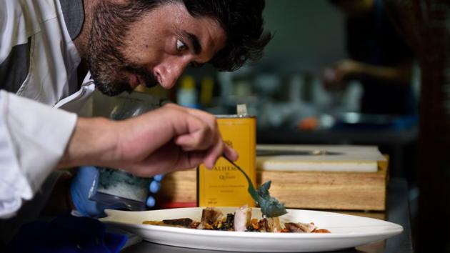 In the town, 18 restaurants now offer healthier dishes by promoting an Atlantic-style diet full of seafood. “I replace salt with algae, fish infusions or a simple dehydrated mussel, and butter with virgin olive oil,” said Diego Platas, a 37-year-old restaurant owner as he cooked a local mackerel. (Miguel Riopa / AFP) In the town, 18 restaurants now offer healthier dishes by promoting an Atlantic-style diet full of seafood. “I replace salt with algae, fish infusions or a simple dehydrated mussel, and butter with virgin olive oil,” said Diego Platas, a 37-year-old restaurant owner as he cooked a local mackerel. (Miguel Riopa / AFP)