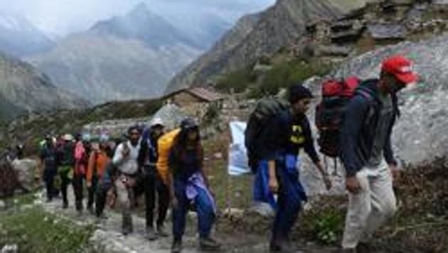 A group from Mumbai heading towards Dronagiri hill. Uttarakhand tourism department recently organized a trekking camp. (HT File Photo)