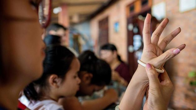 A woman tries an ivory bracelet for sale at a tourist resort in Lien Son town. Actively cutting off tails or plucking hairs was never part of the tradition. “They loved and considered elephants part of their family so they wouldn’t do anything to hurt them,” according to Linh Nga Nie Kdam, a researcher on Ede culture. “They never sold their hair.” (Thanh Nguyen / AFP) 