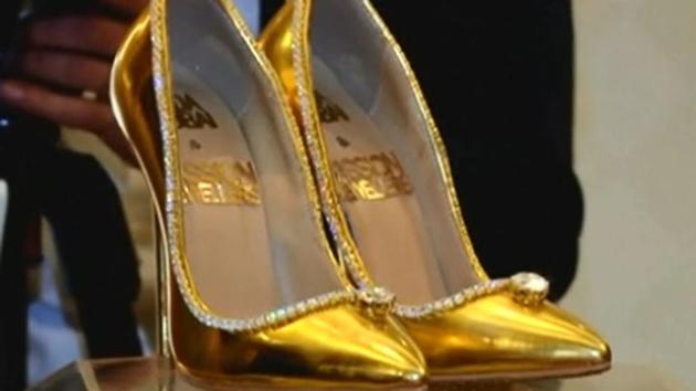 The pumps are made of golden leather decorated with more than 100 carats of flawless diamonds set on white gold.(Reuters)