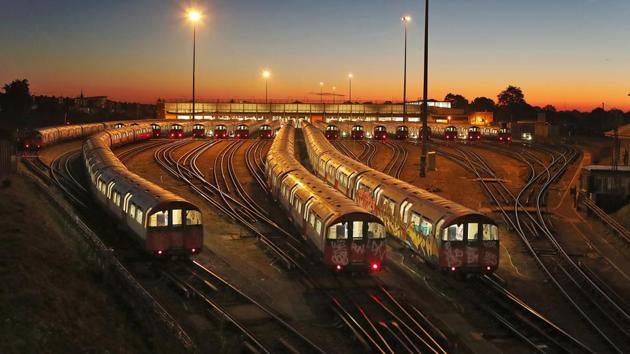 Piccadilly Line underground trains are parked at a depot at Boston Manor station in London, at sunrise during a 48 hour strike. (Frank Augstein / AP) Piccadilly Line underground trains are parked at a depot at Boston Manor station in London, at sunrise during a 48 hour strike. (Frank Augstein / AP)