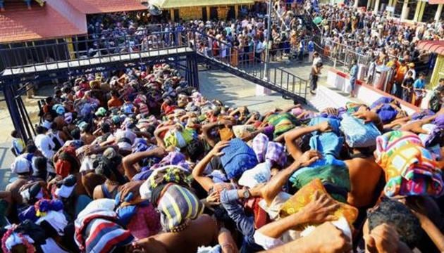 Devotees gather at the Sabarimala Lord Ayyappa Temple, Kerala. There is nothing in the scriptures which decrees that the celibate deity will take umbrage at women in their fertile years entering Sabarimala temple.(PTI)