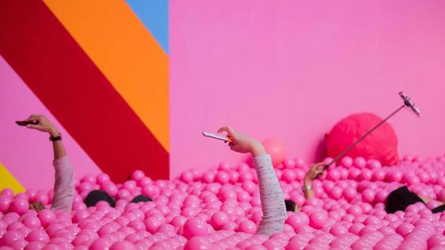 Visitors use their mobile devices to take pictures of themselves posing in a pink ball bath at the Supercandy Pop-Up Museum in Cologne, western Germany. (Rolf Vennenbernd / dpa / AFP) Visitors use their mobile devices to take pictures of themselves posing in a pink ball bath at the Supercandy Pop-Up Museum in Cologne, western Germany. (Rolf Vennenbernd / dpa / AFP)