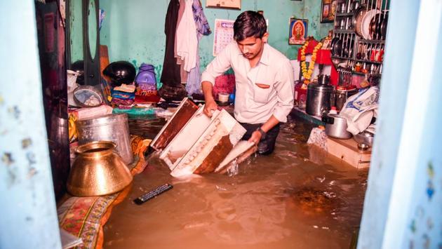 Water sweeps into homes in Dandekar bridge area on Thursday morning catching residents completely unaware. (SANKET WANKHADE/HT PHOTO) Water sweeps into homes in Dandekar bridge area on Thursday morning catching residents completely unaware. (SANKET WANKHADE/HT PHOTO)