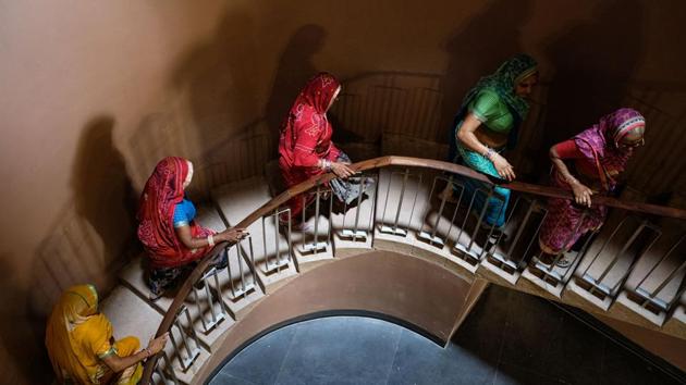 Women walk up stairs while visiting Mehran Fort in Jodhpur, Rajasthan. (Noemi Cassanelli / AFP)