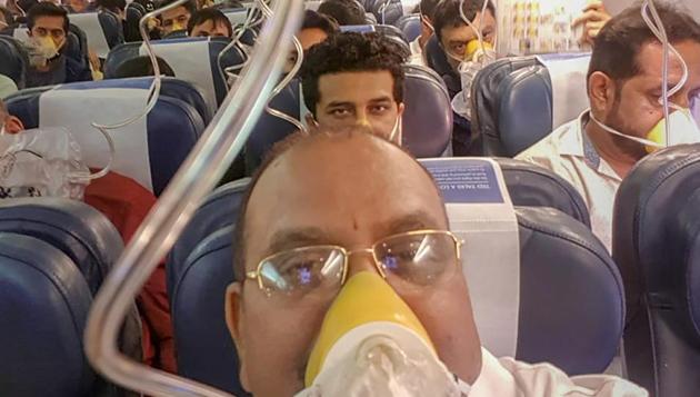 Passengers on board the Mumbai-Jaipur Jet Airways flight wear oxygen masks during an emergency after cabin pressure drop, in Mumbai, September 20(PTI)