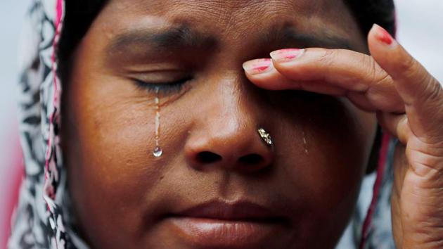 A wife of a sanitation worker who died while cleaning a sewer, cries as she attends a protest against the rising deaths of people cleaning sewers, in New Delhi. (Adnan Abidi / REUTERS)