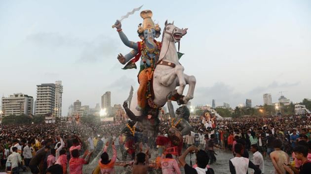 Devotees carry a statue of Ganesha for immersion in the Arabian sea in Mumbai, Maharashtra. (Punit Paranjpe / AFP)
