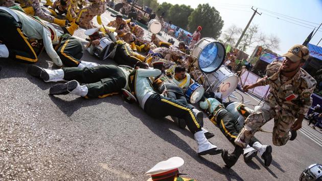 A soldier runs past injured comrades lying on the ground at the scene of an attack on a military parade that was marking the anniversary of the outbreak of its devastating 1980-1988 war with Saddam Hussein’s Iraq, in the southwestern Iranian city of Ahvaz. (Morteza Jaberian / ISNA / AFP) A soldier runs past injured comrades lying on the ground at the scene of an attack on a military parade that was marking the anniversary of the outbreak of its devastating 1980-1988 war with Saddam Hussein’s Iraq, in the southwestern Iranian city of Ahvaz. (Morteza Jaberian / ISNA / AFP)
