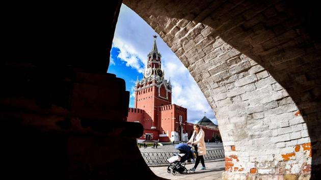 A woman pushes a child in a stroller in downtown Moscow, with the Kremlin’s Spasskaya (Saviour) Tower seen in the background. (Yuri Kadobnow / AFP) A woman pushes a child in a stroller in downtown Moscow, with the Kremlin’s Spasskaya (Saviour) Tower seen in the background. (Yuri Kadobnow / AFP)