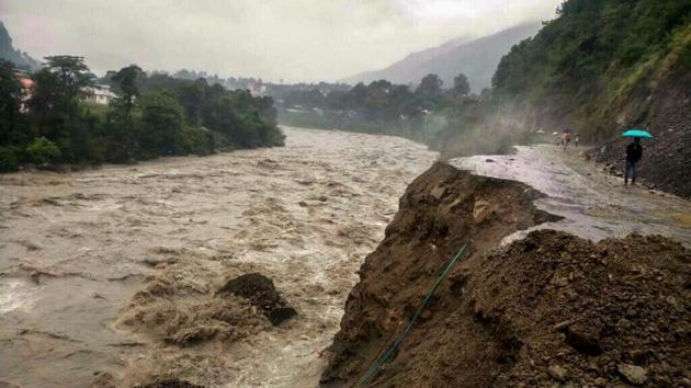 Damaged Pathankot-Chamba highway is seen as heavy gush of flood water flows into Ravi river during incessant rainfall, in Chamba, Himachal Pradesh. (PTI)