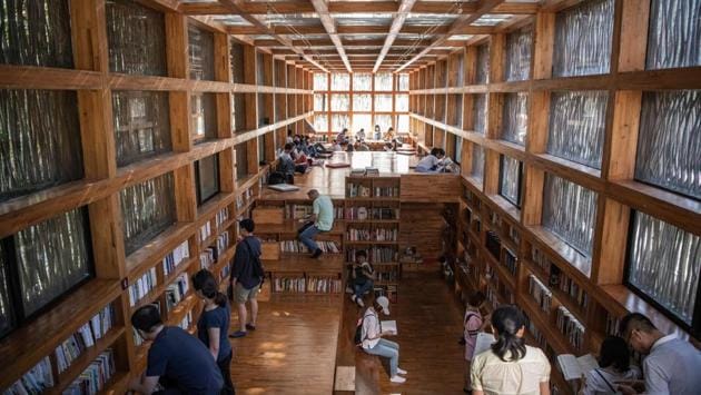 With space for just 40 people at a time, visitors stand in line to enter the library, which only opens on weekends. (Fred Dufour / AFP) With space for just 40 people at a time, visitors stand in line to enter the library, which only opens on weekends. (Fred Dufour / AFP)