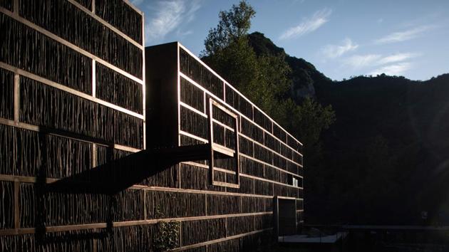 The lush environment is what first drew architect Li Xiaodong to the village -- the library has a steel and glass base but its facade is cladded with branches and twigs arranged in vertical rows. Visitors cross a narrow wooden bridge which leads to a bright and airy space, sunlight seeping in through gaps in the uneven wood, a design feature. (Fred Dufour / AFP) The lush environment is what first drew architect Li Xiaodong to the village -- the library has a steel and glass base but its facade is cladded with branches and twigs arranged in vertical rows. Visitors cross a narrow wooden bridge which leads to a bright and airy space, sunlight seeping in through gaps in the uneven wood, a design feature. (Fred Dufour / AFP)
