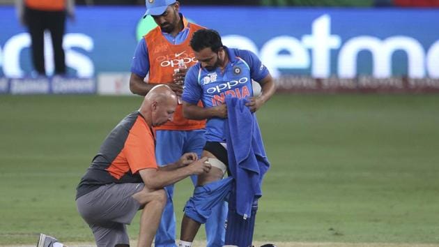 Team physio Patrick Farhart (left) attends to Kedar Jadhav during the India innings in Dubai on Friday. (AP) Team physio Patrick Farhart (left) attends to Kedar Jadhav during the India innings in Dubai on Friday. (AP)