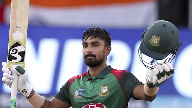 Bangladesh's Liton Das raises his bat and helmet to celebrate scoring a century during the final one day international. (AP) Bangladesh's Liton Das raises his bat and helmet to celebrate scoring a century during the final one day international. (AP)