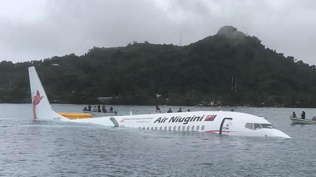 This photo taken by James Benito on September 28, 2018, shows locals approaching the crashed Air Niugini aircraft on the remote Island of Weno, in Micronesia. (AFP Photo) This photo taken by James Benito on September 28, 2018, shows locals approaching the crashed Air Niugini aircraft on the remote Island of Weno, in Micronesia. (AFP Photo)
