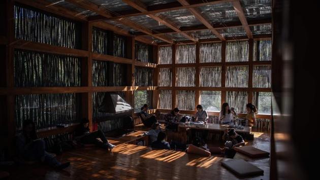 People read at Liyuan Library on the outskirts of Beijing. Bookshelves that double up as walls line the reading area -- basically one large room -- and readers lounge with tomes on the floor or on elevated platforms. (Fred Dufour / AFP) People read at Liyuan Library on the outskirts of Beijing. Bookshelves that double up as walls line the reading area -- basically one large room -- and readers lounge with tomes on the floor or on elevated platforms. (Fred Dufour / AFP)