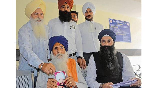 Balbir Singh showing his son Harjit Singh’s photo in Mohali on Saturday. (HT Photo) Balbir Singh showing his son Harjit Singh’s photo in Mohali on Saturday. (HT Photo)