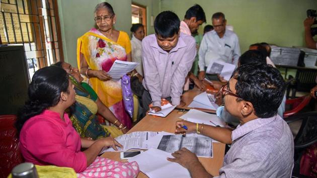 People verify the National Register of Citizens (NRC) forms to file claims and objections at an NRC centre, in Guwahati on September 25, 2018.(PTI Photo)