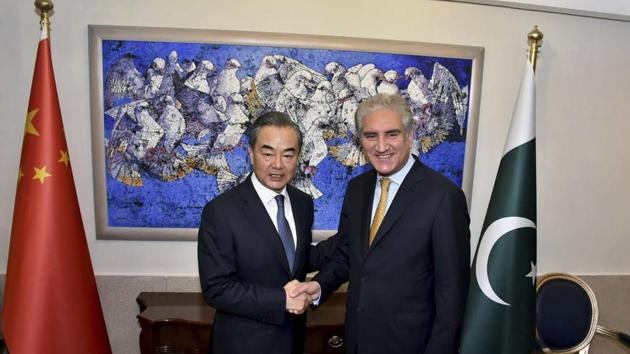 In this picture released by Press Information Department, visiting Chinese foreign minister Wang Yi shakes hand with his Pakistani counterpart Shah Mahmood Qureshi prior to their meeting in Islamabad, Pakistan. (AP File Photo)
