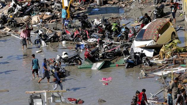 People survey outside the flooded shopping mall which was damaged following earthquakes and a tsunami in Palu, Central Sulawesi, Indonesia. (AP Photo) People survey outside the flooded shopping mall which was damaged following earthquakes and a tsunami in Palu, Central Sulawesi, Indonesia. (AP Photo)