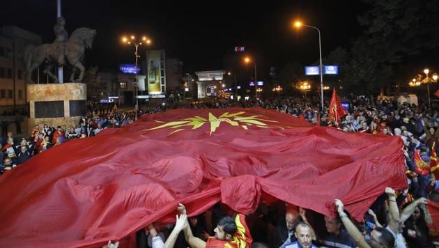 Supporters of a movement for voters to boycott the referendum, hold a huge Macedonian flag as they celebrate in central Skopje, Macedonia, after election officials gave low turnout figures. (AP Photo) Supporters of a movement for voters to boycott the referendum, hold a huge Macedonian flag as they celebrate in central Skopje, Macedonia, after election officials gave low turnout figures. (AP Photo)