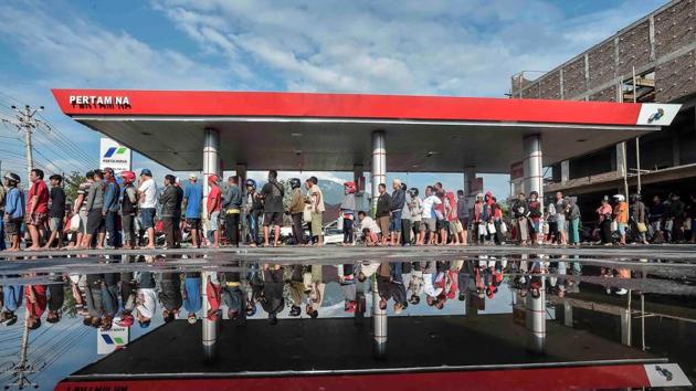 People queue for fuel at a petrol station. The state energy company said it was airlifting 4,000 litres of fuel to help with the rescue effort, while the state logistics agency said it was preparing to send hundreds of tonnes of rice. As per media reports, the government has so far allocated 560 billion rupiah for disaster recovery. (REUTERS) People queue for fuel at a petrol station. The state energy company said it was airlifting 4,000 litres of fuel to help with the rescue effort, while the state logistics agency said it was preparing to send hundreds of tonnes of rice. As per media reports, the government has so far allocated 560 billion rupiah for disaster recovery. (REUTERS)