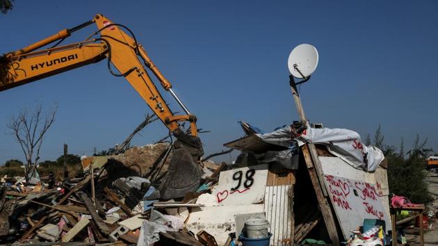A bulldozer demolishes the remaining huts at the Roma shanty town of El Gallinero. “The new house will be better than this, but we grew up here. It feels strange,” said Lipovehnch Bucurestean, 21, heavily pregnant with her second child. (Susana Vera / REUTERS) 