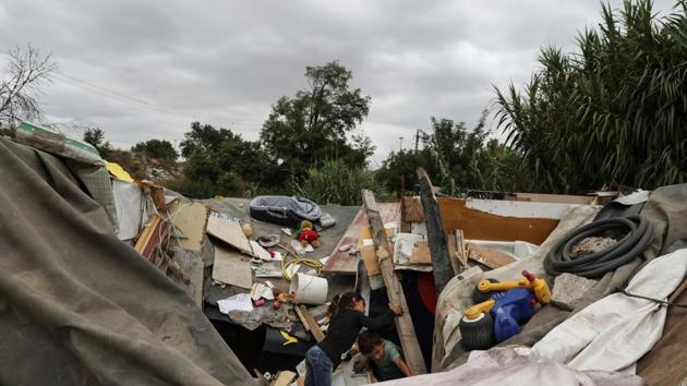 Children look for toys to salvage from the debris of the Stan family hut after it was demolished. Bucurestean’s toddler son picked through old toys strewn around their make-shift house as the Red Cross arrived to transport them to their new home. Meanwhile, scrap collectors from another Roma community arrived in search of leftovers. (Susana Vera / REUTERS) 