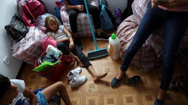 Members of the Stan family rest surrounded by their belongings in their new apartment. There are around 725,000-750,000 ethnic Roma living in Spain, according to the charity Minority Rights, making it one of the largest communities of its kind in Europe. Roma from Romania make up a significant part of that number and, as Europeans, are permitted to live and work in Spain without visas. (Susana Vera / REUTERS) 