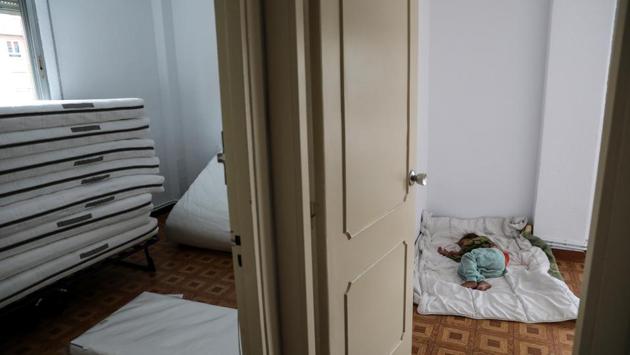 Marta Stan, 2, sleeps on the floor as her family moves into their new apartment after being relocated from El Gallinero. “We aren’t dirty,” said Dayana, 6, hinting at the prejudice her family have sometimes faced outside of their tight-knit Roma community. (Susana Vera / REUTERS) 