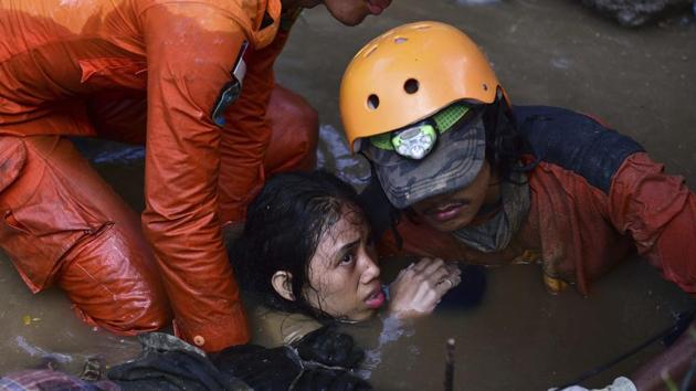 Rescuers evacuate an earthquake survivor from a damaged house. Nearly 17,000 people were rendered homeless in Palu alone, and many aid agencies were busy ensuring that their own staff members were alive and safe. (AP) Rescuers evacuate an earthquake survivor from a damaged house. Nearly 17,000 people were rendered homeless in Palu alone, and many aid agencies were busy ensuring that their own staff members were alive and safe. (AP)