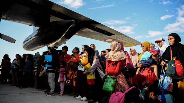 Residents affected by an earthquake and tsunami wait to be evacuated by military aircraft. Officials said rescuers need heavy equipment to shift slabs of broken concrete but access to many areas has been hampered by damaged roads, landslides and collapsed bridges. (REUTERS) Residents affected by an earthquake and tsunami wait to be evacuated by military aircraft. Officials said rescuers need heavy equipment to shift slabs of broken concrete but access to many areas has been hampered by damaged roads, landslides and collapsed bridges. (REUTERS)