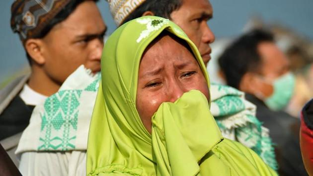 A woman cries as people assess the damage after the tsunami. The meteorological and geophysics agency BMKG issued a tsunami warning after the quake but lifted it 34 minutes later, drawing criticism that it had been too hasty. But officials estimated the waves had hit while the warning was in force. (Muhammad Rifki / AFP) A woman cries as people assess the damage after the tsunami. The meteorological and geophysics agency BMKG issued a tsunami warning after the quake but lifted it 34 minutes later, drawing criticism that it had been too hasty. But officials estimated the waves had hit while the warning was in force. (Muhammad Rifki / AFP)