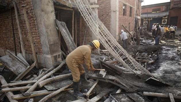 A Delhi Fire Service (DFS) personnel during a rescue operation after a portion of an unauthorised under-construction building collapsed in Swaroop Nagar, in New Delhi, on Monday, October 1, 2018. (Burhaan Kinu/HT PHOTO) A Delhi Fire Service (DFS) personnel during a rescue operation after a portion of an unauthorised under-construction building collapsed in Swaroop Nagar, in New Delhi, on Monday, October 1, 2018. (Burhaan Kinu/HT PHOTO)