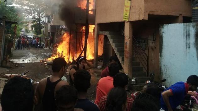 A fire broke out from a transformer in Shivshambho society located in Jai Malhar Nagar of Thergaon on Saturday. Three people were injured in the explosion of a transformer and a tempo and a bike standing near the transformer were burnt. (HT PHOTO)