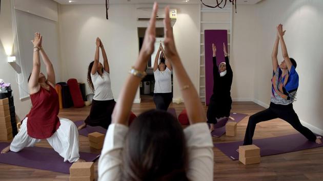 Nouf Marwaai, 38, the head of the Arab Yoga Foundation (foreground), instructs her students at her studio in the western Saudi Arabian city of Jeddah. In a sparse, wood-floored studio, Saudi women squat, lunge and do headstands. Even a year ago, teaching these yoga postures could have rendered them outlaws in the conservative Islamic kingdom. (Amer Hilabi / AFP)