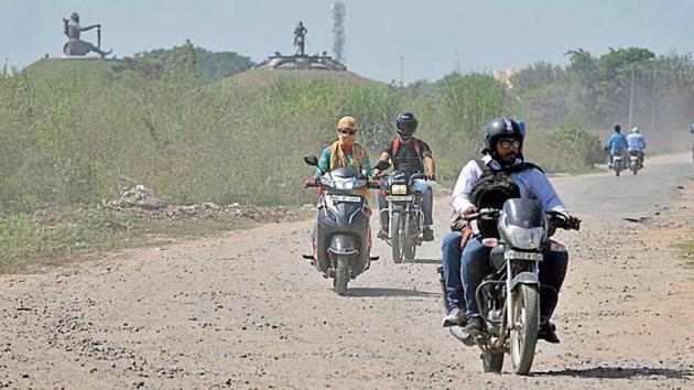Two-wheeler riders on the Fateh Burj memorial road in Chappar Chiri on Wednesday. (HT Photo) Two-wheeler riders on the Fateh Burj memorial road in Chappar Chiri on Wednesday. (HT Photo)