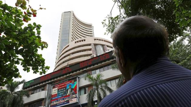 A man looks at a screen across a road displaying the Sensex on the facade of the Bombay Stock Exchange (BSE) building in Mumbai, India, June 29, 2015.(Reuters File Photo) A man looks at a screen across a road displaying the Sensex on the facade of the Bombay Stock Exchange (BSE) building in Mumbai, India, June 29, 2015.(Reuters File Photo)